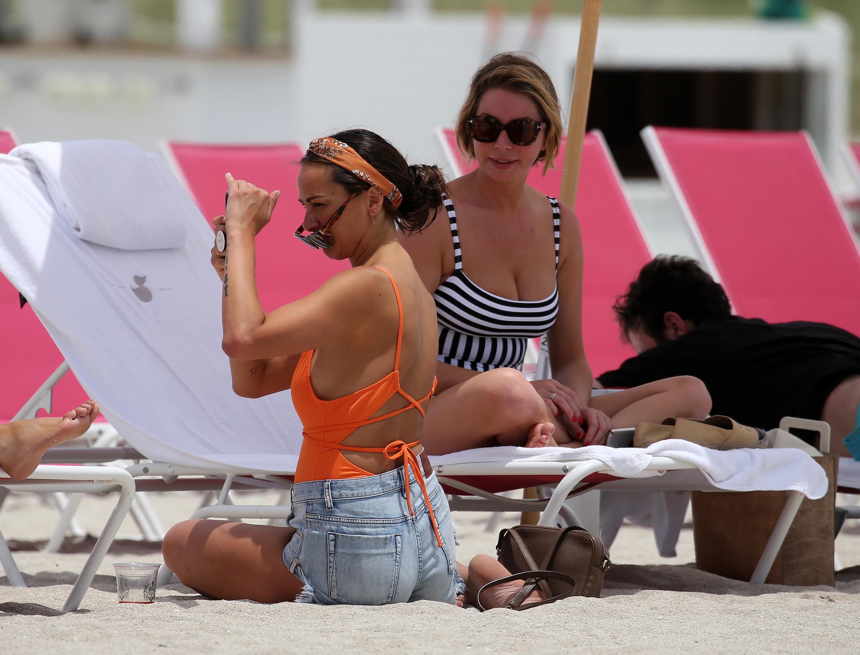 Vanderpump Rules star Kristen Doute poses topless as Stassi Shroeder and Scheana Marie Shay take pictures on the beach in Miami